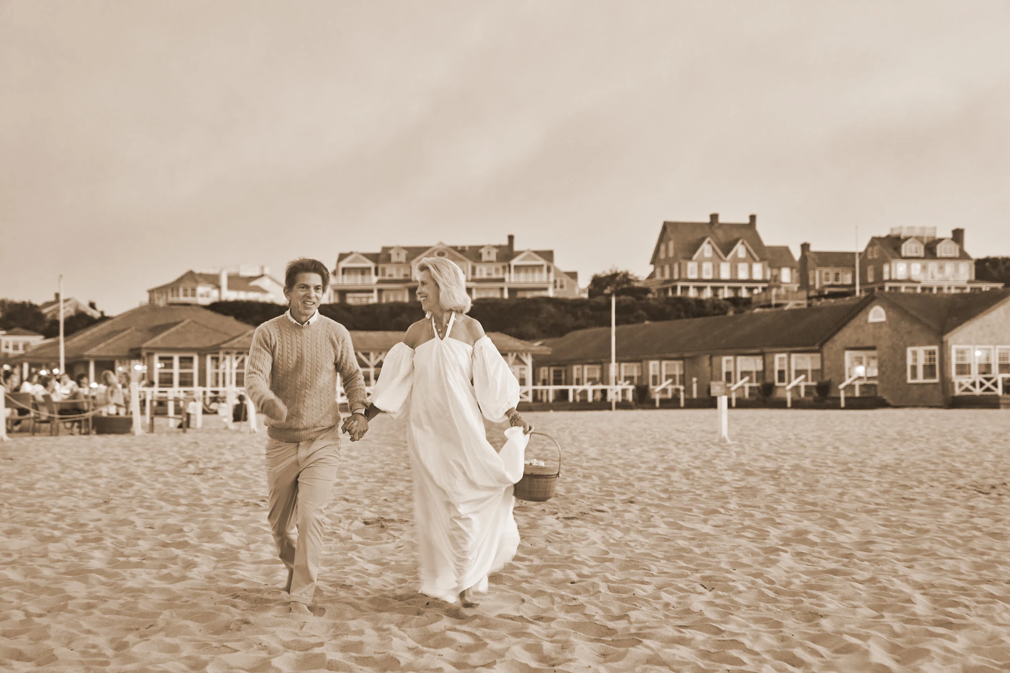 A couple walking hand in hand on the Nantucket beach